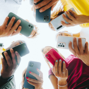 A circle of friends holding smart mobile phones