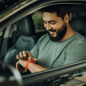 A parked man checking his message using his smartwatch