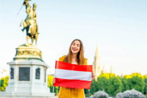 A traveler holding the flag of Austria