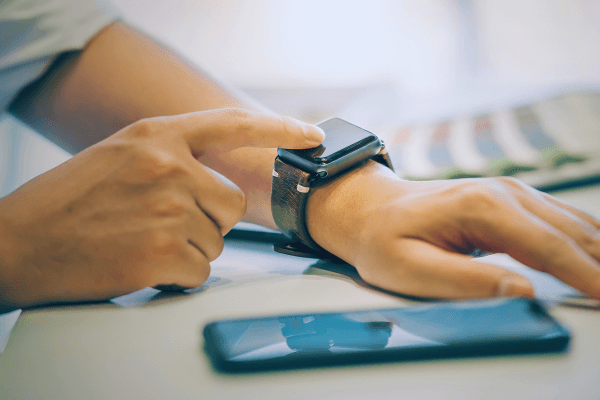 Businessman using smartwatch while working at office