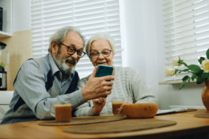 The elderly couple using smartphone