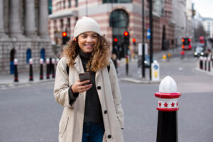 young-woman-using-her-smartphone-city