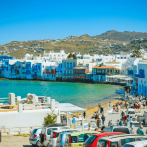 Vibrant hues of blue and white adorn the picturesque streets where sun-kissed charm meets Aegean tranquility
