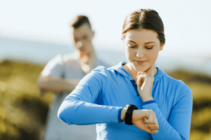 A woman runner using heart rate monitor
