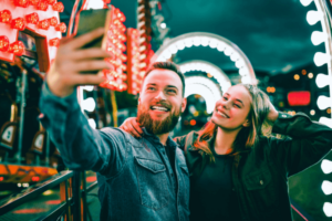 Couple taking selfie at theme park