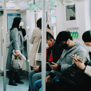 People inside train using their phones during pandemic