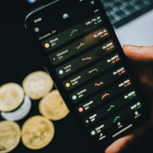 A person holding a smartphone using cryptocurrency with bitcoins