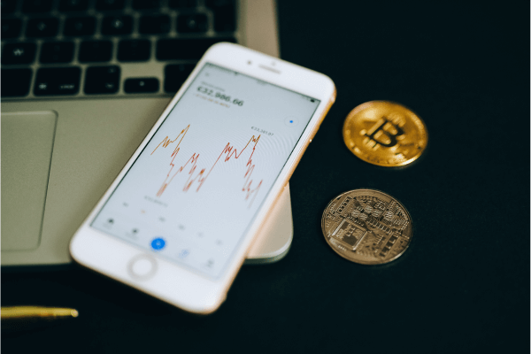 Close up shot of a smartphone and bitcoins in cryptocurrency