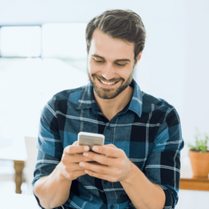 Happy man using mobile phone