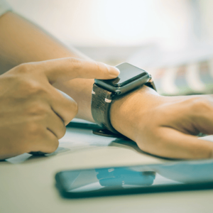 Man using smartwatch while working at office