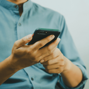 Close up of a man using mobile smart phone