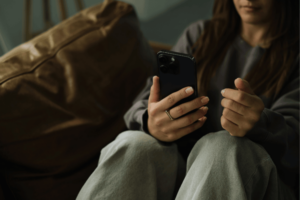Cropped Shot of Woman Using Smartphone at Home