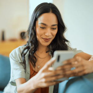 Happy mixed race woman using phone with new app