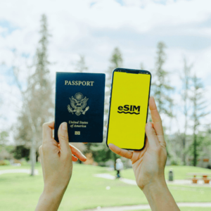 Holding Passport and Smartphone with eSim Application