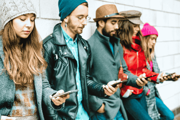 Millennials Using Their Smartphone Outdoors