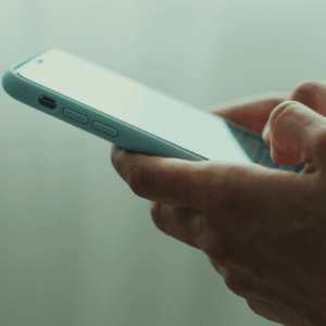 Hand of woman using texting mobile phone or chat