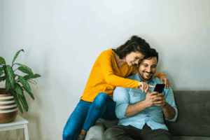Happy couple using phone
