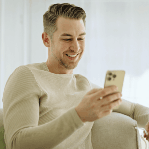 miling Man Using Cell Phone