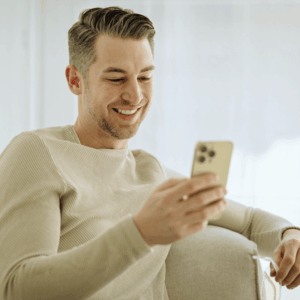 Smiling Man Using Cell Phone