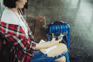 Young Woman Using Mobile Application for Travel
