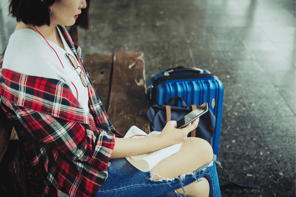 Young Woman Using Mobile Application for Travel