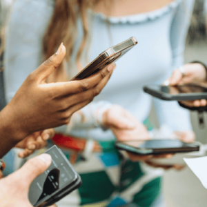 Gen Z Londoners holding smart phones using social media