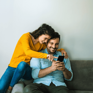Happy couple using phone