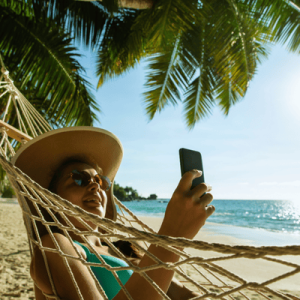 Smiling Woman Using Mobile Phone On Beach