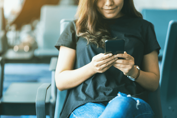 traveler using mobile phone in the airport