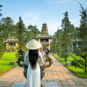 Anonymous woman standing against temple in Vietnam