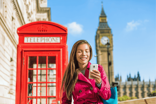 Female Tourist Using a Cellphone in London