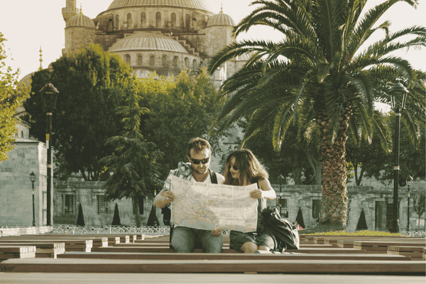 Tourist couple reading map and traveling in Istanbul