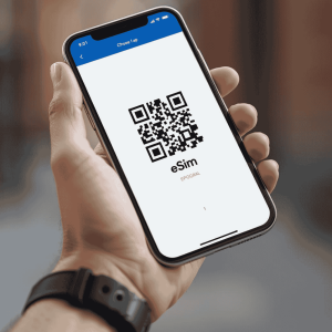 a person holding a mobile phone with eSIM QR code