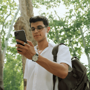 Man Using Phone Among Trees