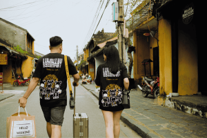 Unrecognizable couple of travelers walking on urban road