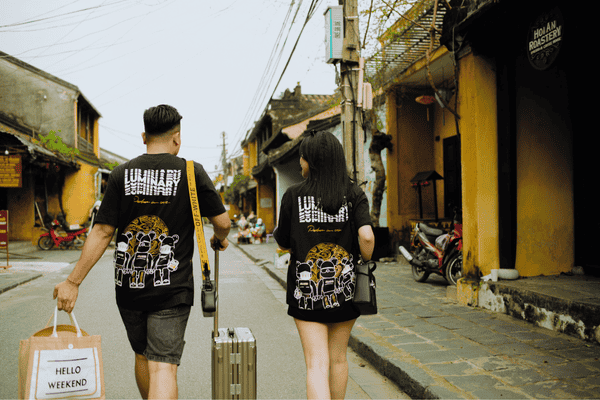 Unrecognizable couple of travelers walking on urban road