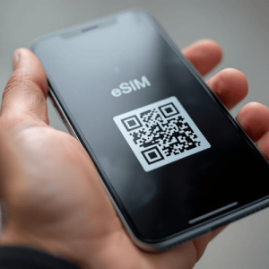 a hand holding phone with eSIM QR code activated