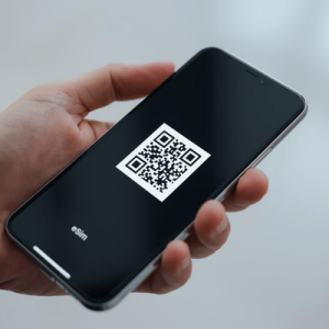 a hand holding a mobile phone activated with eSIM QR code