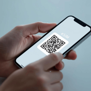 a hand holding a smartphone with activated eSIM QR code