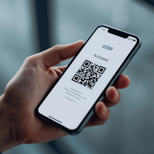 a hand holding a smartphone with activated eSIM QR code