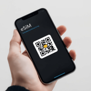 a hand holding a smartphone with activated eSIM QR code