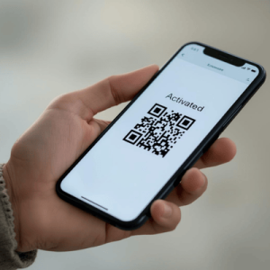 a hand holding a smartphone with activated eSIM QR code