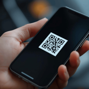 a hand holding a smartphone with eSIM QR code