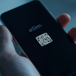 a hand holding a smartphone with eSIM QR code