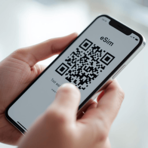 a hand holding a smartphone with eSIM QR code