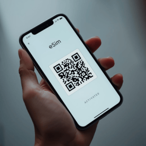 a hand holding smartphone with eSIM QR activated