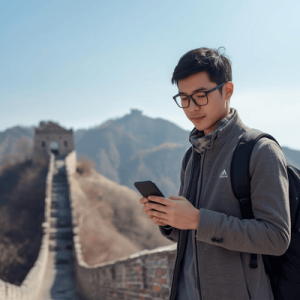 a tourist holding a smartphone while on Great Wall of China