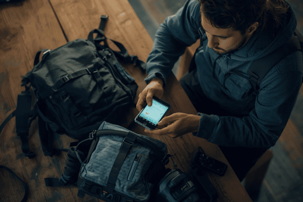 a traveler preparing stuffs and holding a smartphone