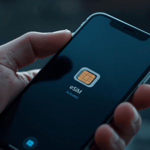 a close-up hand holding a smartphone with eSIM activated