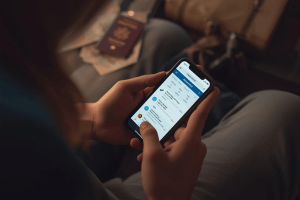 a traveler preparing a trip abroad while using a smartphone